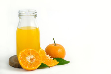 Fresh orange juice above wood coaster, with raw, sliced orange fruit – isolated on white background