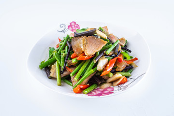 Fried bacon with wild bracken on a plate on white background
