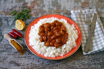 Selective focus. Plate of rice with vegan curry. Cooking at home. Curry Sauce. Vegan food.