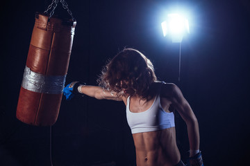 Young sexy Woman boxer. Martial arts or self defence.  Fitness girl training kick boxing. Boxing...