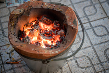 Stove charcoal.orange flames of coals in the grill / Charcoal stove burning.Brazier charcoal burning ready to grill in solid stove,feel cliam and warm at night.