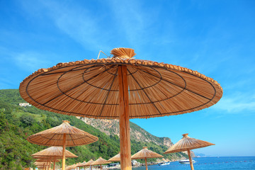 reed beach umbrellas at exotic tropical beach