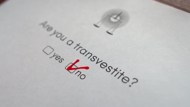 Close-up of hand putting check mark in the test. The hand ticks no when answering the question " Are you a transvestite "