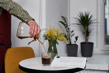 Alternating filter manual brewing of coffee close up. Devices for coffee in the background