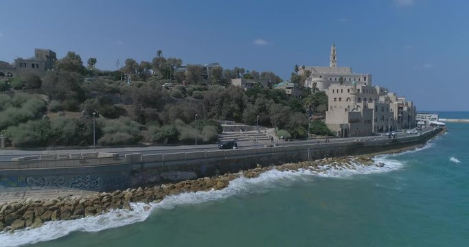 Tel Aviv - Jaffa. Aerial Drone footage. Fly towards saint peter's church in Jaffa to Tel Aviv beaches and Skyline cityscape