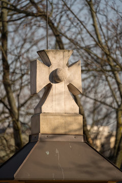 Stone cross crowning rooftop spire