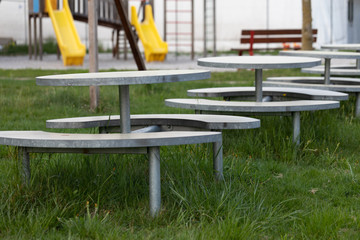 Row of empty outdoor tables and benches