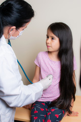 Colombian girl is examined by her pediatrician in the consulting room