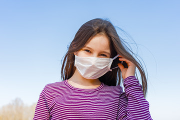 Little optimistic happy girl wearing mask for protect pm2.5