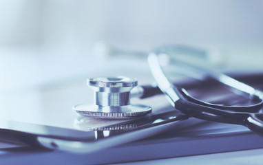 Medical equipment: blue stethoscope and tablet on white background. Medical equipment