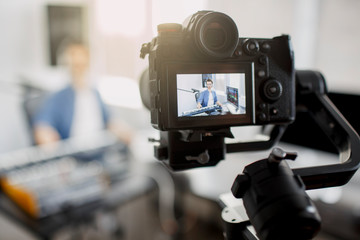 The live video blogger teaches how to make music tracks live. Video for social network or stream....