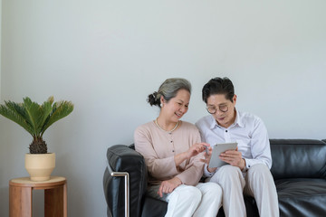 An Asian elderly couple using a tablet