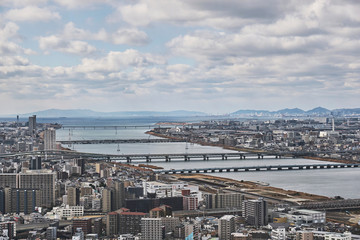 Obraz premium Osaka City and River Panorama Under Heavy Clouds