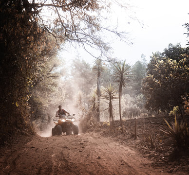 Man on ATV in dusty Guatemala mountains 
