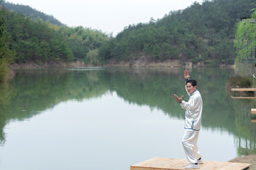 Naklejka premium An old Asian man punching Tai Chi