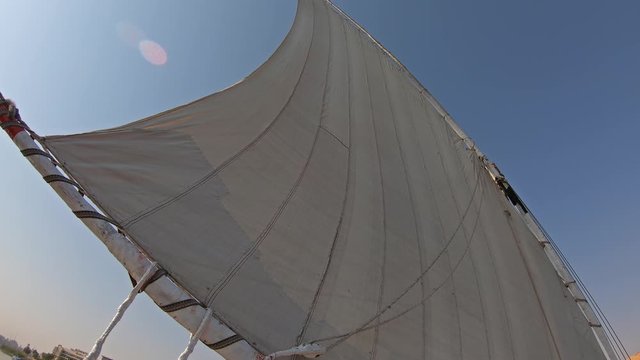 View from below on white sail of felucca boat in Egypt, 4k