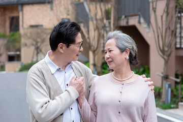 An Asian elderly couple walking