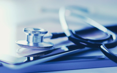 Medical equipment: blue stethoscope and tablet on white background. Medical equipment