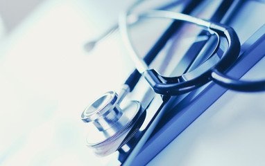 Medical equipment: blue stethoscope and tablet on white background. Medical equipment