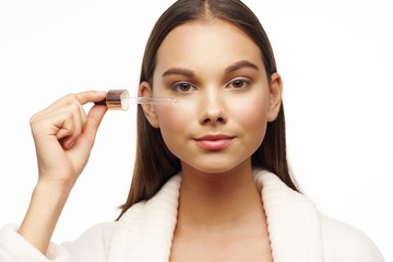 young woman applying mascara