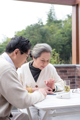 An old Asian couple using a sphygmomanometer