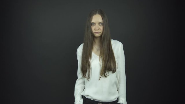 attractive brunette in blouse performs anger at audition