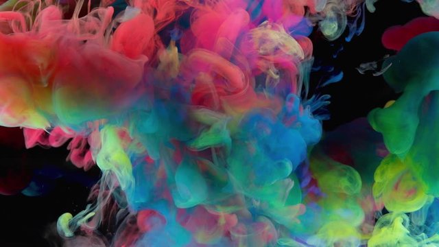Color paint drops in water , abstract color mix , drop of Ink color mix paint falling on water Colorful ink in water, 4K footage, 