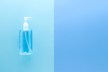 Alcohol hand gel sanitizer for cleaning to protect from virus and germ during COVID-19 pandemic top view on light blue background with copy space for text