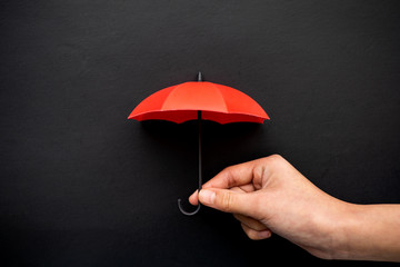 Hand hold a red umbrella 3D icon isolated on black background