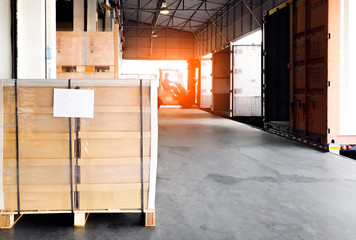 Interior of distribution warehouse, stack of package boxes, large pallet shipment goods, truck dock warehouse loading cargo , road freight industry delivery, shipping ,logistics and transport