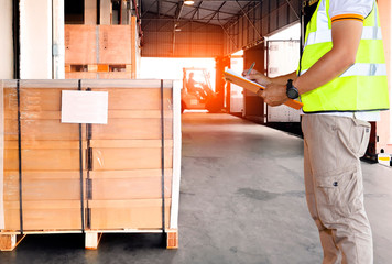 Warehouse and Logistics, Worker courier holding clipboard inspecting control load shipment goods...