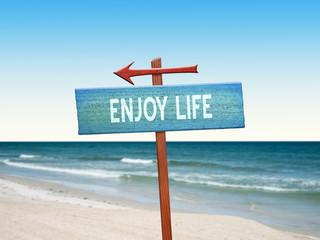 Enjoy Life sign at the beach.