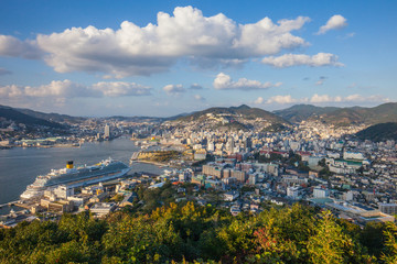 Fototapeta na wymiar Nabekanmuri Park Observation Platform city in Japan, High angle view of Nagasaki park. Garden, nature and city view, seaside city in asia with harbor and boat on blue sea, observatory of the bay.