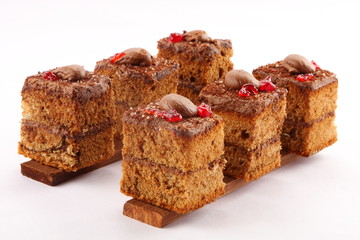 Oven fresh  chocolate cream cake slices on a white background.