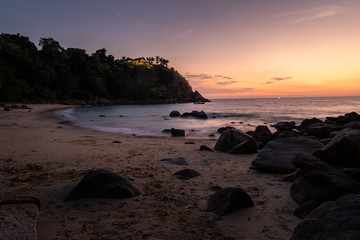 banana beach, phuket, thailand with dramatic sunset sky