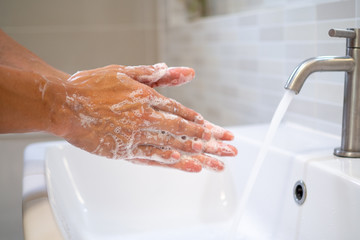 Women using gel to wash hands and turn on water to wash is the treatment and prevention of infections or viruses that are currently spreading around the world.