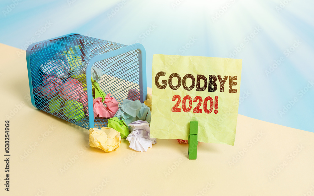 Wall mural Writing note showing Good Bye 2020. Business concept for express good wishes when parting or at the end of last year Trash bin crumpled paper clothespin reminder office supplies