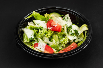 salad with cucumber and tomatoes in plastic box