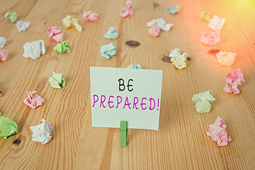 Handwriting text Be Prepared. Conceptual photo try be always ready to do or deal with something Colored crumpled papers empty reminder wooden floor background clothespin