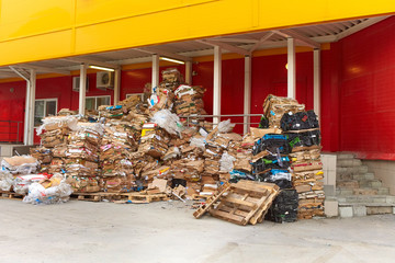 A dump of cardboard boxes in the back of a supermarket. The concept of pollution of the urban environment