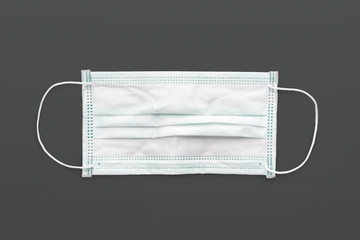 Surgical mask with rubber ear straps isolated on white with clipping path. White mask to cover the mouth and nose.