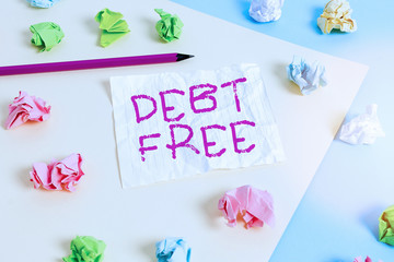 Text sign showing Debt Free. Business photo showcasing free from owning any money to any individual or a company Colored crumpled papers empty reminder blue yellow background clothespin