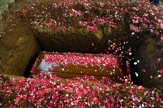 High Angle View Of Flowers On Coffin At Cemetery