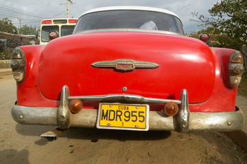 Old red Pontiac with a Cuban license plate in Havana, Cuba
