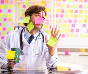 Male doctor with many conflicting prioritites