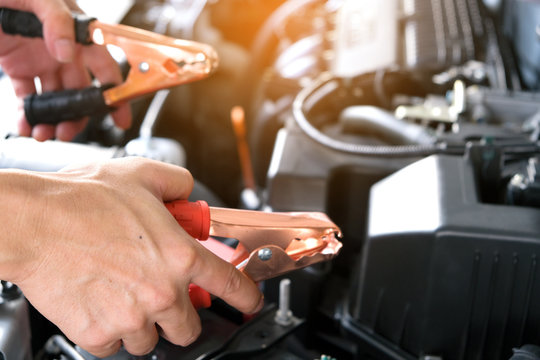 Car maintenance technician He is checking the auto engine, car inspection center.