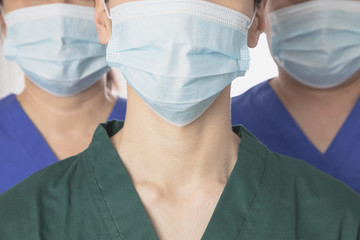 Team of Asian doctors wearing protective masks