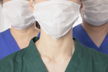 Team of Asian doctors wearing protective masks