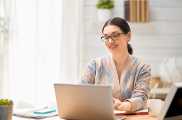 Woman working on a laptop.