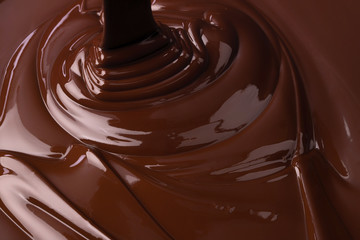 melted dark chocolate background. pouring liquid cocoa dessert